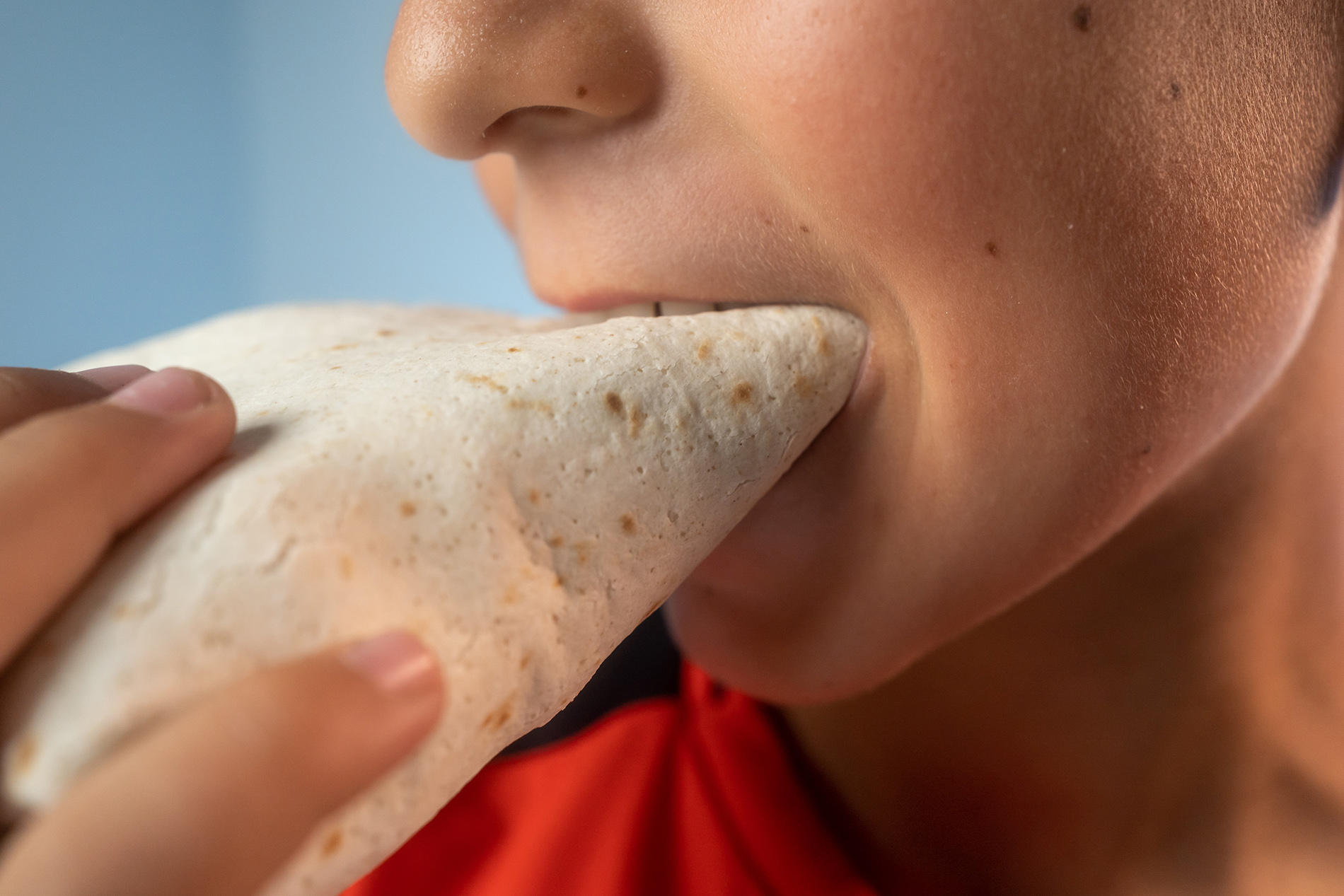 Kid eating Burrito